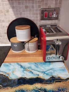 two coffee cups sitting on a counter next to a toaster at Canterbury within the city wall - Sleeps 7 - Pet-Friendly with Garden in Canterbury