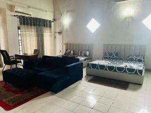 a living room with a bed and a couch at Relax On Plus Kelaniya in Kelaniya +3 photos