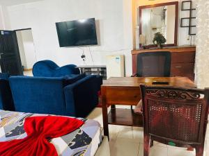 a living room with a blue couch and a table at Relax On Plus Kelaniya in Kelaniya
