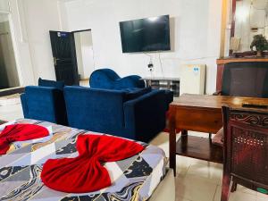 a living room with two beds and a tv at Relax On Plus Kelaniya in Kelaniya