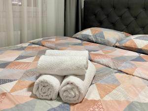 a bed with towels and pillows on it at FILIP Apartment with garage in Doboj