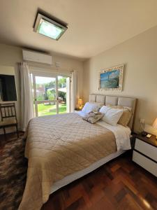a bedroom with a large bed with a window at Pousada Casa Thede in São Salvador +117 photos