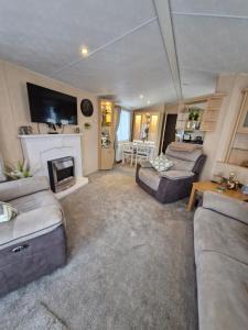 a living room with a couch and a fireplace at Ocean Front Lodge in Hartlepool
