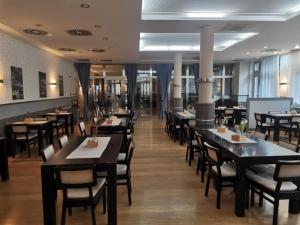a dining room with tables and chairs in a restaurant at Hotel Monde in Uherský Brod