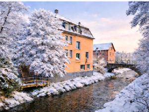 a building next to a river with a bridge at Murgtalhouse Ferienwohnungen in Murg