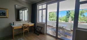 a room with a desk and a table with chairs at Big Sky Ranch in Colesberg