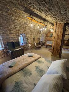 a bedroom with a large bed in a brick wall at Bayt Wadad, Bcharre Lebanon in Bcharré
