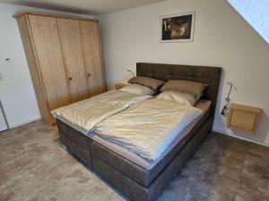 a bedroom with a large bed in a room at Torwirt Apartments in Herrieden