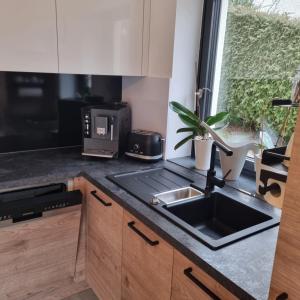 a kitchen with a sink and a microwave at Moderne Ferienwohnung,im fränkischen Seenland , 25 min Messe Nbg in Roth