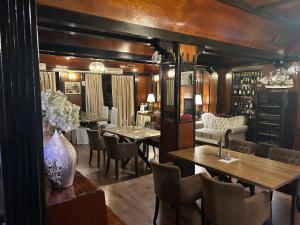 a restaurant with wooden walls and tables and chairs at Hotel Martini Zagreb Hotel and Restaurant in Sesvete