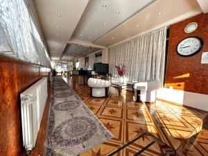 a lobby with a clock and a living room at Hotel Martini Zagreb Hotel and Restaurant in Sesvete