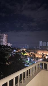 a view of a city at night from a balcony at One Bedroom with Balcony in Abreeza Mall in Davao City