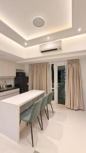 a kitchen with a table and chairs in a room at One Bedroom with Balcony in Abreeza Mall in Davao City