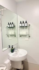 a white bathroom with a sink and a mirror at One Bedroom with Balcony in Abreeza Mall in Davao City +35 photos