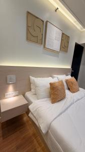 a bedroom with a bed with white sheets and pillows at One Bedroom with Balcony in Abreeza Mall in Davao City