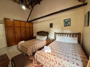 a bedroom with two beds in a room at De Rust Private Nature Reserve in Odendaalsrus +30 photos