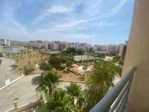 a view of a park with palm trees and buildings at Super Logement in Tangier