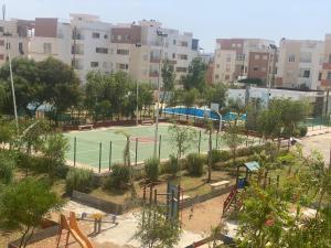 a playground with a tennis court in a city at Super Logement in Tangier +4 photos