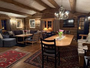 a dining room with a table and chairs and a chandelier at Large cottage with beautiful view in Trysil in Trysil