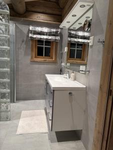a bathroom with a white sink and a mirror at Large cottage with beautiful view in Trysil in Trysil +33 photos