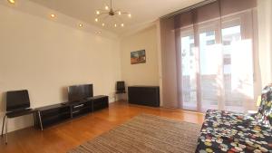 a living room with a couch and a flat screen tv at Casa di Giada - Venice Gateway - Family Comfort - Free Public Parking& Tram -Link in Mestre