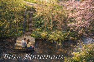 a man and woman sitting on a bench in a park at Murgtalhouse Ferienwohnungen in Murg