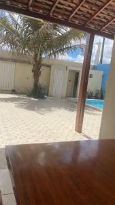 a view of a patio with a table and a palm tree at Casa grande in Garanhuns