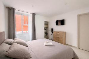 a bedroom with a bed with a white towel on it at Appartement T3 Place du Marché in Bastia