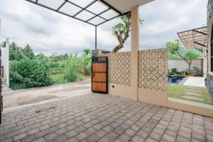 an open door of a house with a patio at Golden Villa Lovina in Lovina