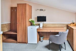 a room with a desk and a tv and a chair at Villa Sulejówek in Sulejówek