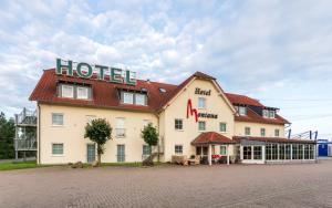 a hotel with a sign on the side of it at Hotel Montana Lauenau in Lauenau