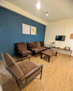 a living room with couches and a flat screen tv at Relax Apartment Toppass in Nuwara Eliya