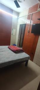 a room with a bench in front of a mirror at Panchmukhi inn hotel in Lucknow