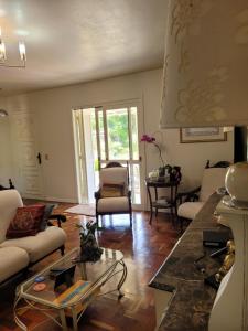 a living room with a couch and a table at Pousada Casa Thede in São Salvador