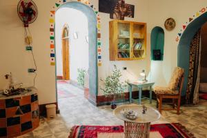 a room with two arches and a table in a room at Harmonia House in Al Karnak