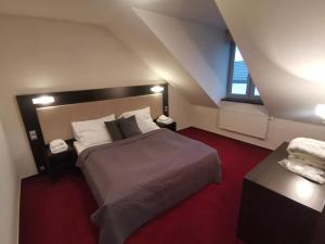 a bedroom with a large bed and a window at Hotel Monde in Uherský Brod +77 photos