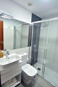 a bathroom with a toilet and a sink and a shower at El Baladero in Telde +111 photos