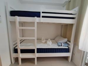 a couple of bunk beds in a room at Urdaneta City Modern Condo in Bayaoas +2 photos