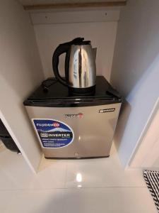 a tea kettle sitting on top of a box at Urdaneta City Modern Condo in Bayaoas