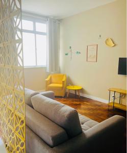 a living room with a couch and a chair at Apartamento Charme da Glória in Rio de Janeiro