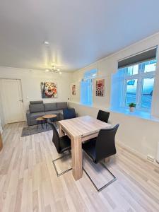 a living room with a wooden table and chairs at Cozy Apartment in Central Alesund Close to Everything in Ålesund