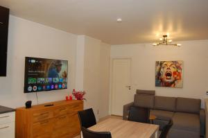a living room with a couch and a table at Cozy Apartment in Central Alesund Close to Everything in Ålesund