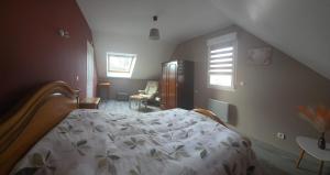 a bedroom with a bed and a staircase with windows at Chambre proche circuit 24h du mans in Spay