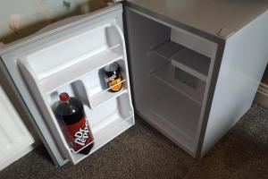 an open refrigerator with a bottle of soda in it at Annie's Accommodation in South Shields