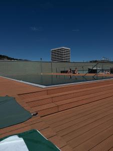 two people sitting on a volleyball court on a deck at Zurich City Appartement in Zurich
