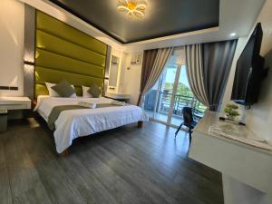 a hotel room with a bed and a television at Dream'Star Resort in Puerto Galera