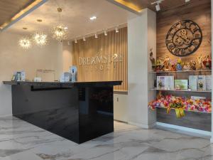 a store lobby with a large clock on the wall at Dream'Star Resort in Puerto Galera +60 photos