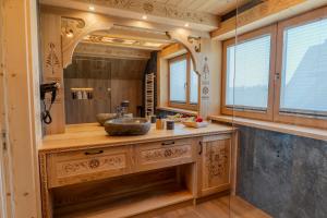 a bathroom with a sink and a large mirror at Domki Góralska Przystań in Białka Tatrzańska