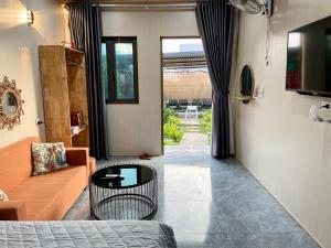 a living room with a couch and a table at Mộc Homestay - Mộc Châu in Mộc Châu