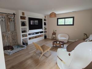 a bedroom with a bed and a dog laying in a room at Villa Signature in Le Bosc